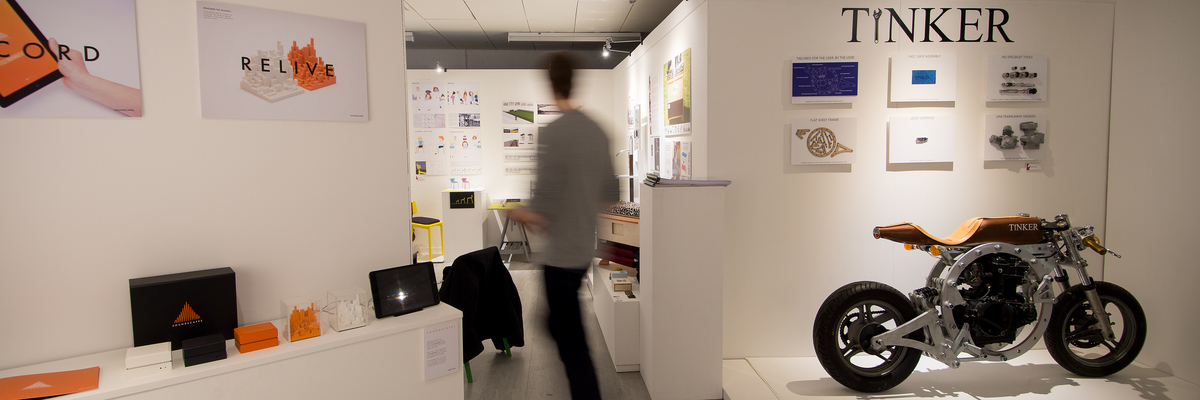 Person walking through Tinker studio surrounded by displays