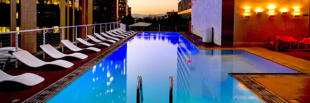 A swimming pool on the rooftop of a hotel. 