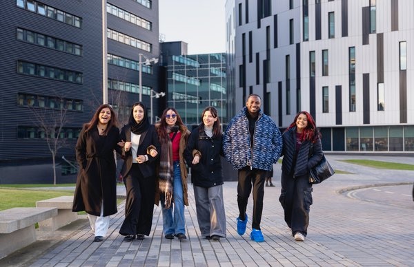 students smiling in front of a napier campus