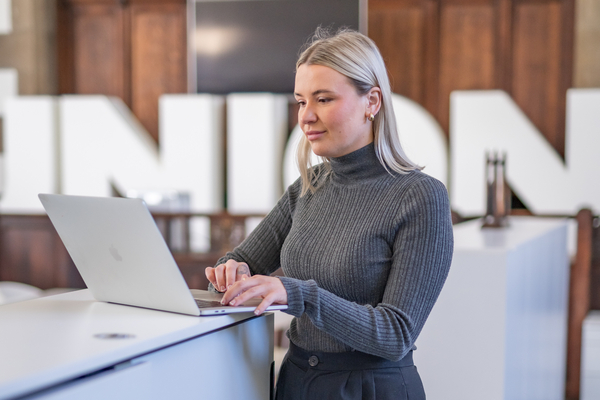 An image of our postgraduate alumni, Jordan, looking at her laptop. 