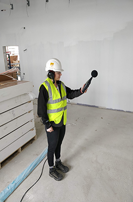 beX scholar, Louise Rogers, in a high visibility jacket and hard hat