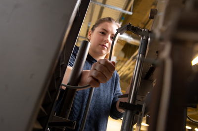 Louise Rogers working on a machine