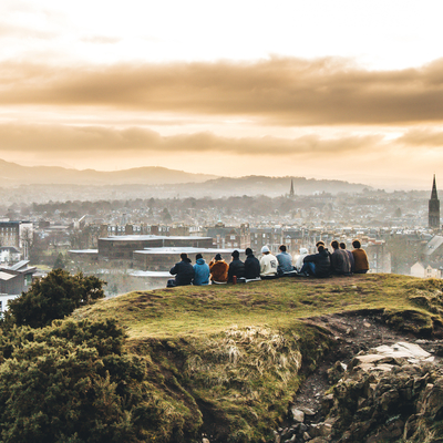 Students sitting on Arthur's Seat looking out over Edinburgh.
