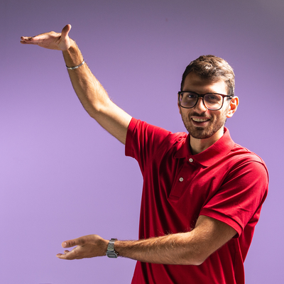 Computing student, Francesco Belvedere, standing in front of a purple backdrop