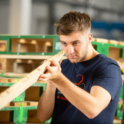 Calum Stuart, a beX scholar, looking at wood