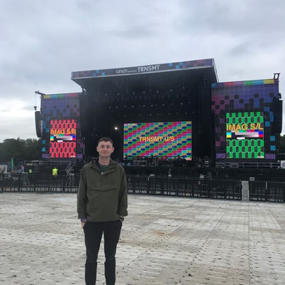 Cameron Hughes standing in front of a stage