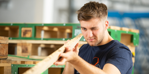  4th year Civil Engineering student looking at wood, during the international beX work experience during summer 2019.
