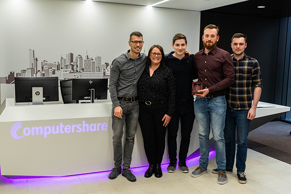 Students posing next to the Computershare sign