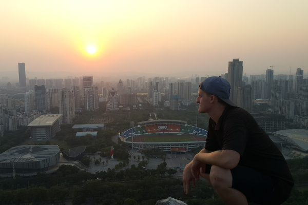 Mechanical Engineering student, Matus Lucky, in front of a Chinese city scape