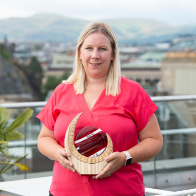 Nathalie holding her Alumni Award