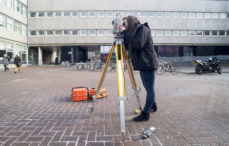Student using surveying equipment
