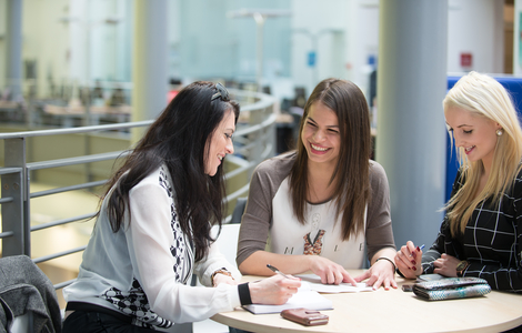 Students laughing and chatting around a table in Craiglockhart campus