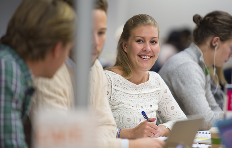 Photo of students smiling while working together
