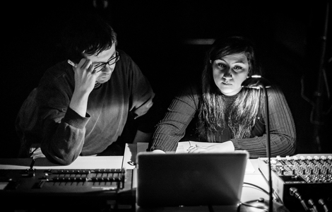 Black and white image of Students on the MFA Directors course working on a sound system for the Shakespeare production