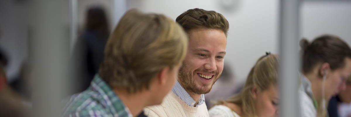 Edinburgh Napier students chatting and smiling as they work