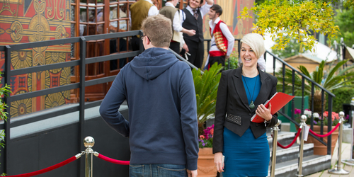 Napier student studying MSC International Marketing laughing and chatting outside a decorated building