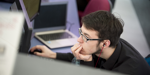 Student concentrating at a computer.