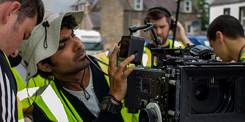 Film students working with a camera on set