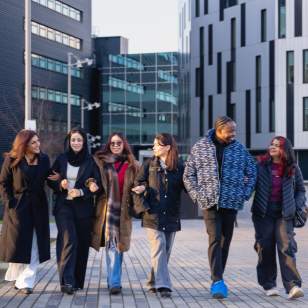Group of students walking together on a university campus.