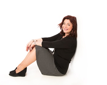 Lynne Cadenhead, sitting down, leaning against a wall