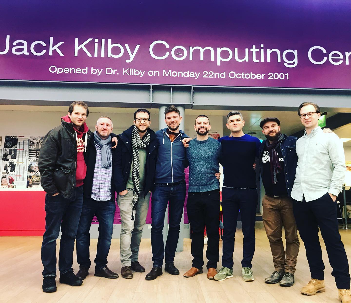 Whisky Society reunion in front of the Jack Kilby Computing Centre sign