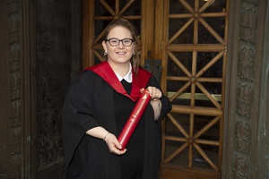 Ann Cumming Prize for Dementia Care winner, Leeann Muir on graduation day, wearing graduation robes and a scroll holder