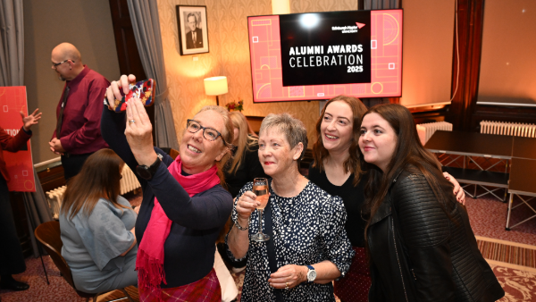 A group of people taking a selfie at an event
