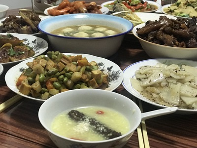 A photo of a table covered in food for Lunar New Year