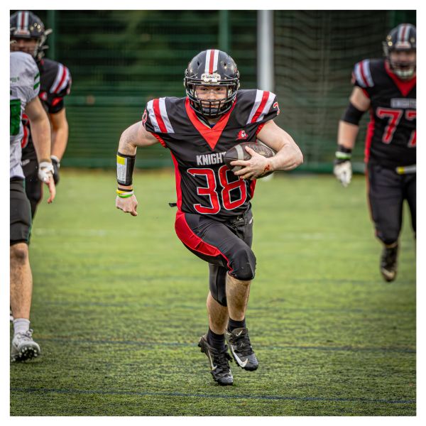 A American Football player from Edinburgh Napier's team, Napier Knights running with the ball