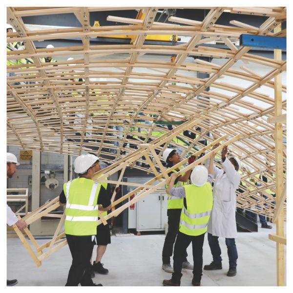 Students building a bamboo frame