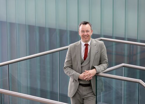 Gary Hutchison standing on a staircase at Sighthill campus