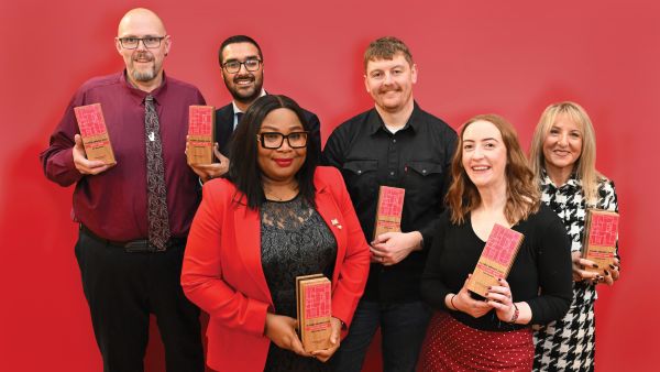 The 2026 Alumni Awards winners holding their trophies