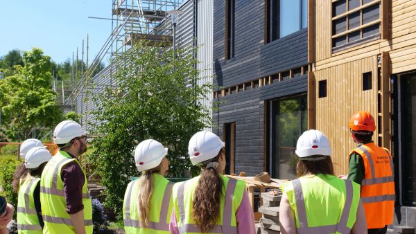 Students a BE-ST viewing a building being retrofitted using sustainable sourced timber