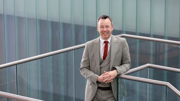 Vice Principal Gary Hutchison standing on a staircase