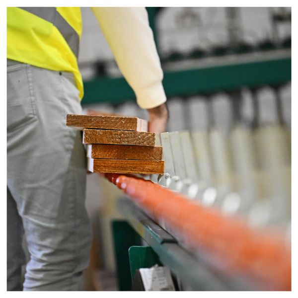 A student holding planks of timber
