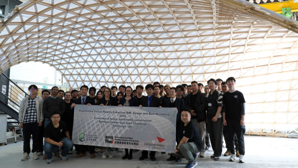 crew posing in front of Bamboo structure