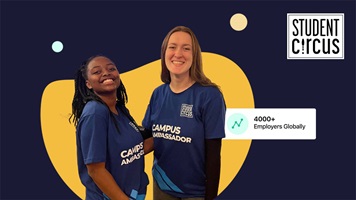 Two students smiling at the camera