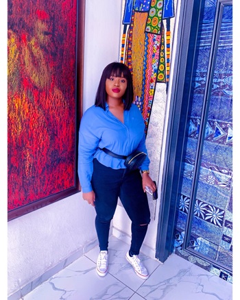 A women standing in front of pieces of colourful art in an art gallery