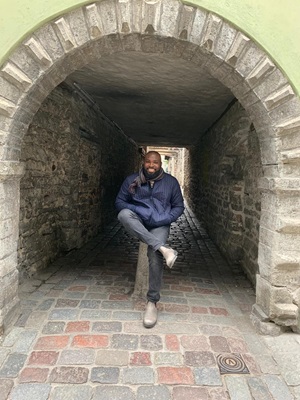 Man sitting in a tunnel, smiling at the camera