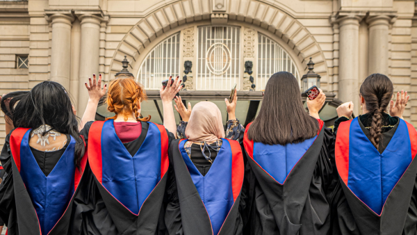 Graduates posing outside Usher Hall