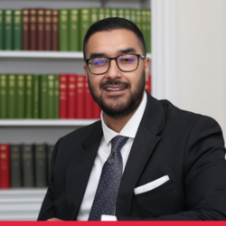 Portrait photograph of Bilaal Shabbir, red strip at the bottom
