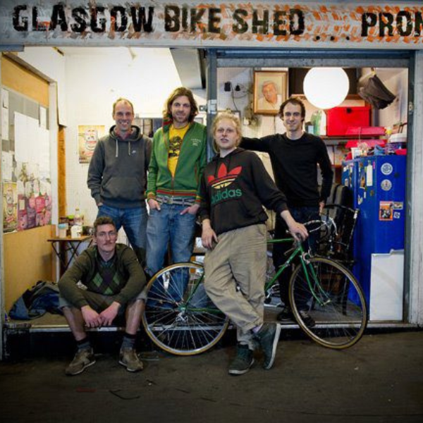 Alumnus Gregory Kinsman-Chauvet standing in front of Bike for Good social enterprise
