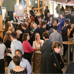 Event space full of guests, networking and chatting