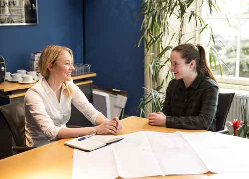 Image of two people having a meeting