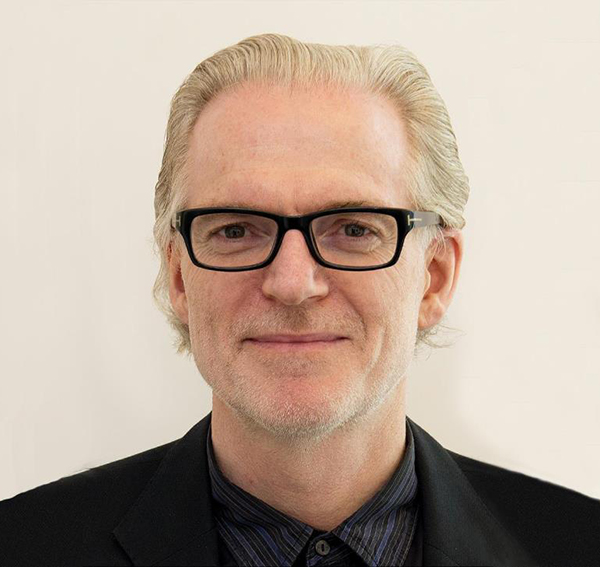 Professor Brian King smiling against a cream-coloured background