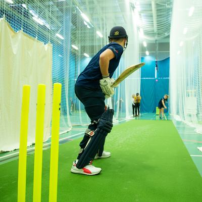 Cricket Scotland academy player ready to bat in front of yellow stumps