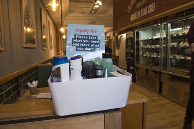 A Dignity Box full of toiletries at a cafe