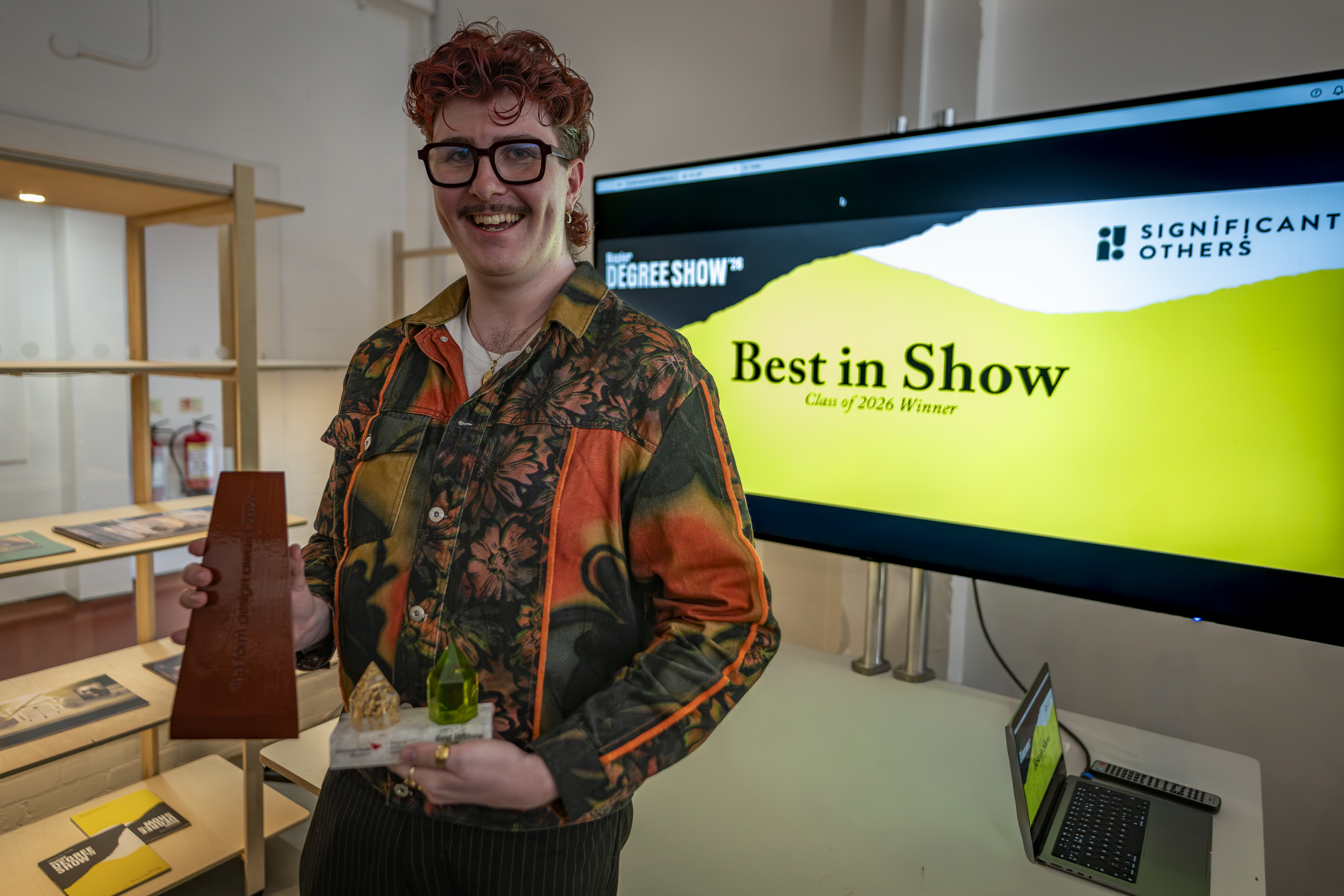 A student receives a Degree Show award