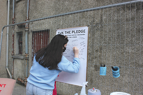 A member of the public signs the Tak A Pledge commitment