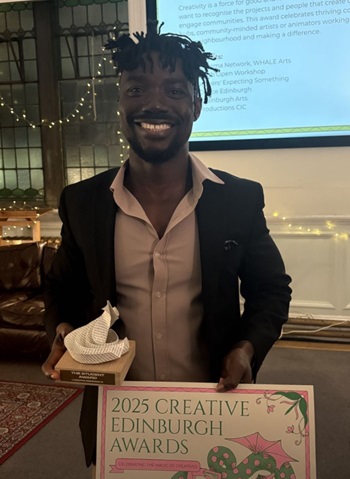Evans Eghan holding his Creative Edinburgh Award